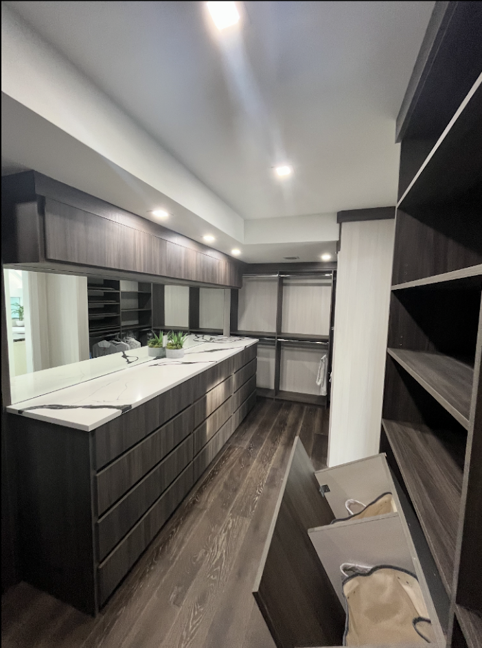 Finished custom closet with built-in drawers and shelving