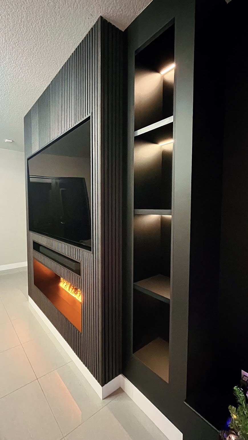 Custom entertainment wall with fireplace and lighted shelves