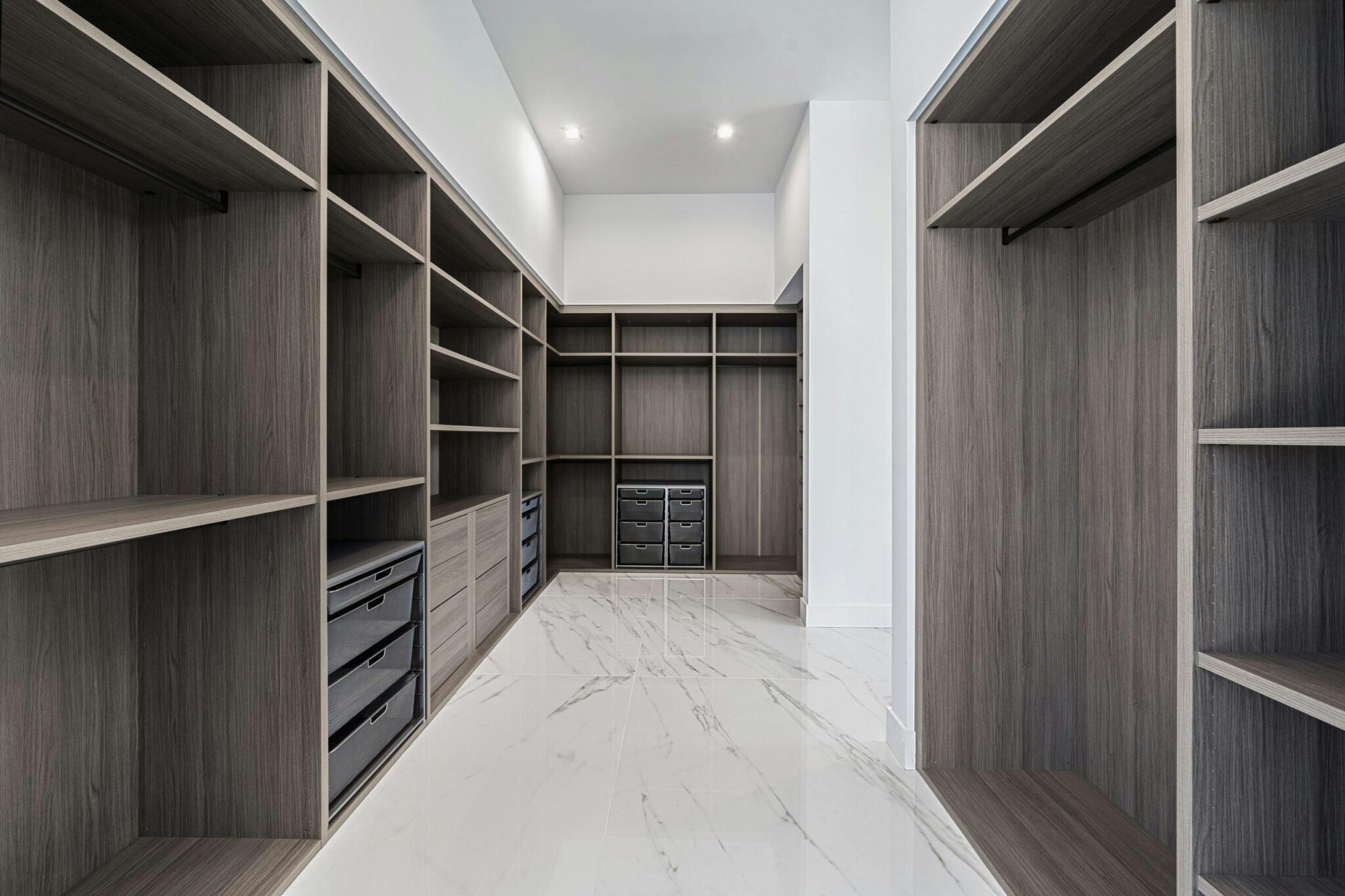 Custom closet storage system with wood shelves and drawers